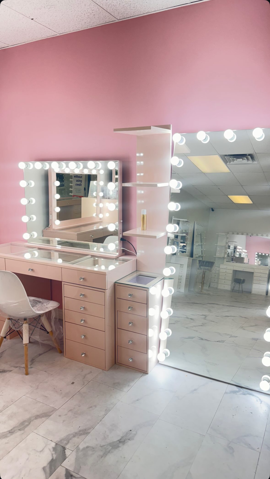 Blush pink vanity with lit mirror and full-length mirror